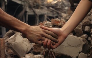 Dos manos que se estrechan sobre los escombros del terremoto